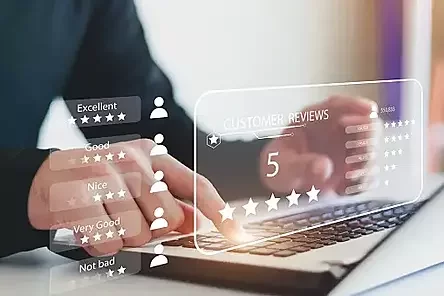 Customer on a laptop, leaving a five star review.